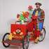 Bobo le clown sculpteur de ballons sur son triporteur